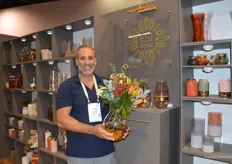 Collin Biggs of FSI Decor holding a flower vase as an example of the added value they were showcasing.